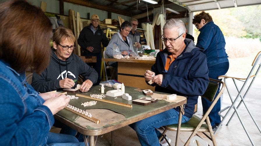 Ken's Bible Study group helps assemble the wooden toy cars